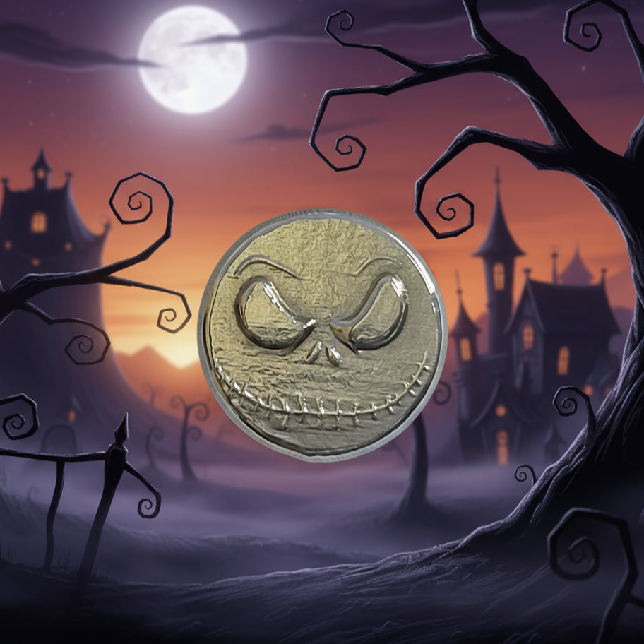 hand poured polished zinc round  with a face design on a light gray background