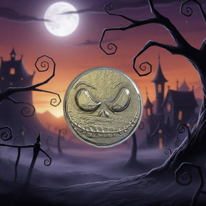 hand poured polished zinc round  with a face design on a light gray background