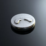 hand poured polished zinc round with a jack skellington skull design on a white background