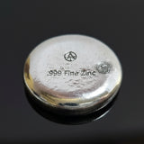 hand poured polished zinc ingot with '999 Fine Zinc' marking on a white background