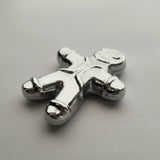 Silver toy figure on a gray background