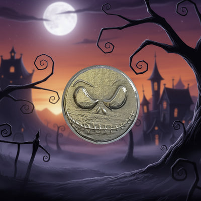 hand poured polished zinc round  with a face design on a light gray background