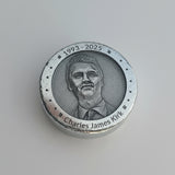 Close-up of a polished zinc round with a portrait etched onto the front